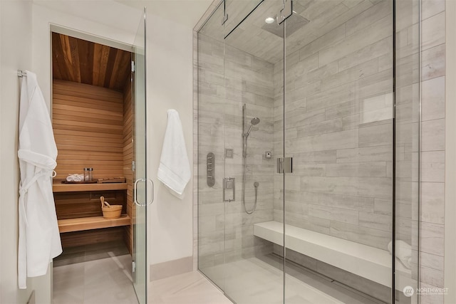 bathroom featuring an enclosed shower and tile patterned floors