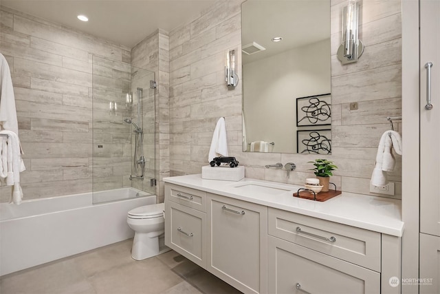 full bathroom with tiled shower / bath, vanity, toilet, and decorative backsplash