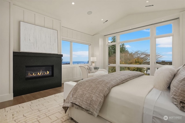 bedroom featuring vaulted ceiling and light hardwood / wood-style flooring