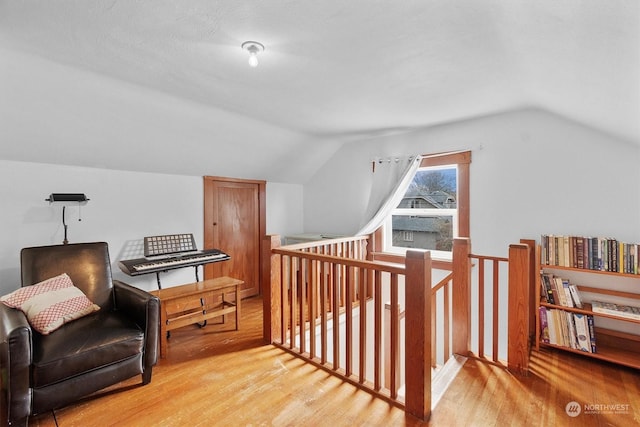 sitting room with vaulted ceiling and light wood-type flooring