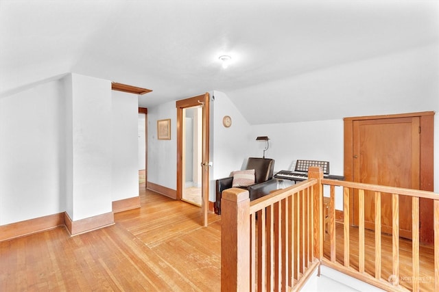 bonus room with light hardwood / wood-style flooring and lofted ceiling