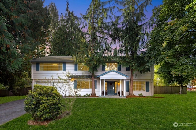 view of front of house featuring a lawn and a garage