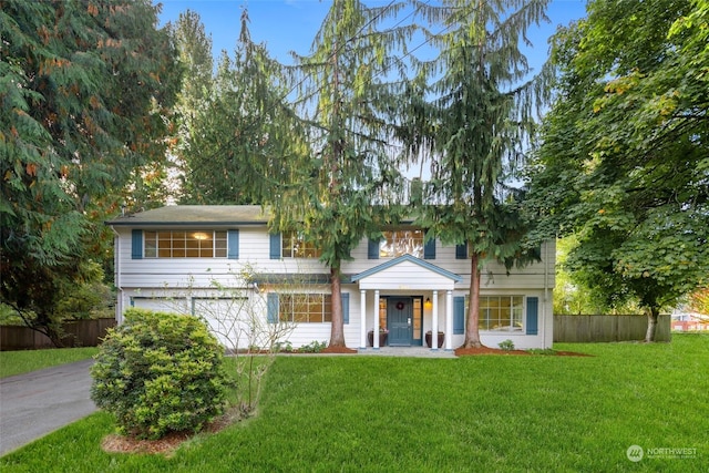 view of front of property with a front lawn and a garage