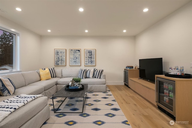 living room featuring beverage cooler and light hardwood / wood-style flooring