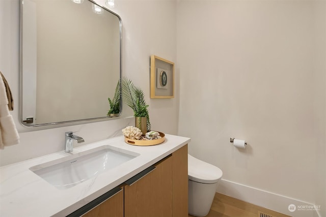 bathroom with vanity and toilet