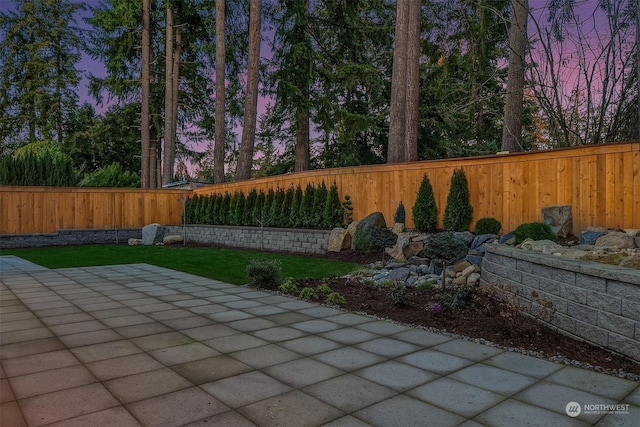 view of patio terrace at dusk