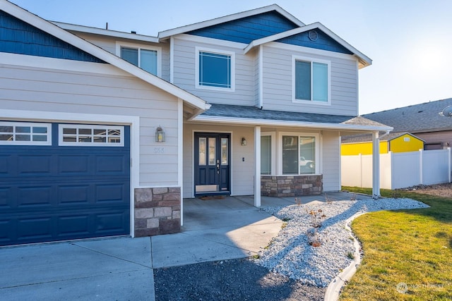 view of front of home featuring a garage and a porch