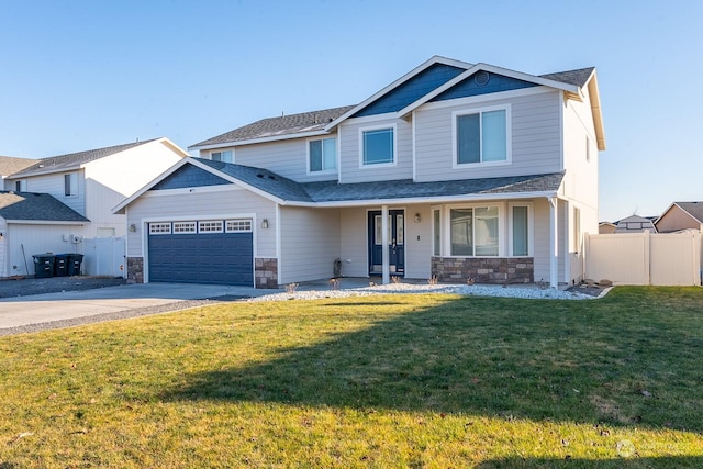 craftsman inspired home featuring a garage and a front lawn