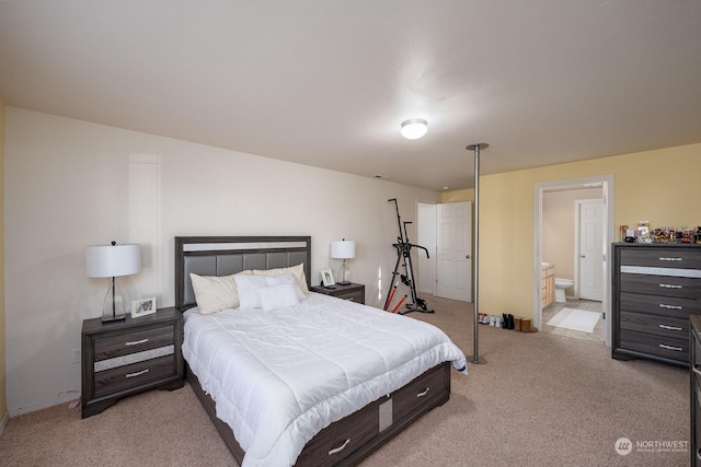 carpeted bedroom featuring ensuite bath