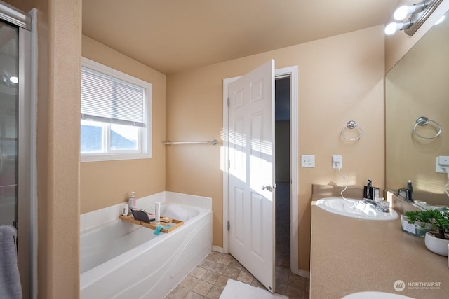 bathroom featuring tile patterned flooring, sink, and a bath