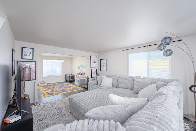 living room with a notable chandelier and a healthy amount of sunlight