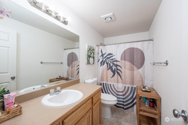 bathroom with vanity, curtained shower, and toilet