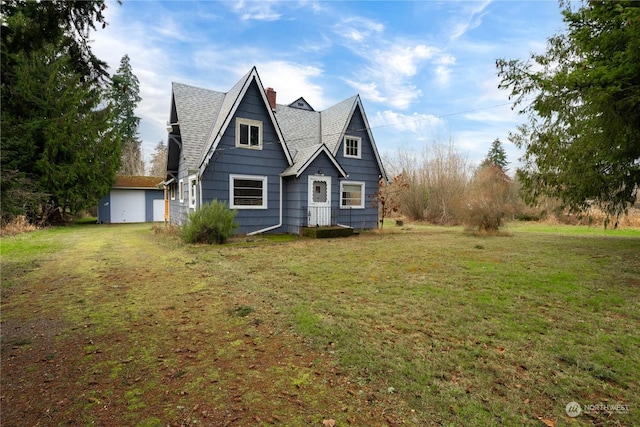 view of front of house with a garage and a front lawn