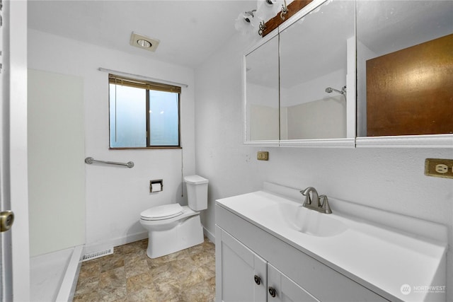 bathroom featuring toilet and vanity