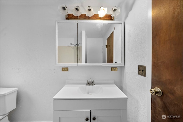 bathroom featuring toilet and vanity