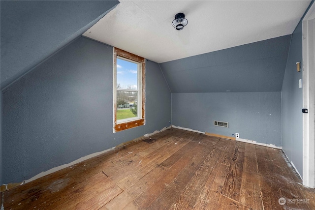 bonus room featuring vaulted ceiling and hardwood / wood-style floors