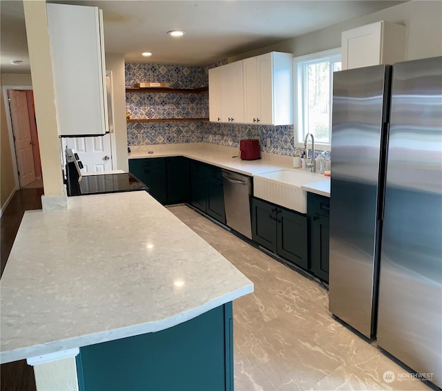 kitchen featuring white cabinetry, appliances with stainless steel finishes, sink, and decorative backsplash