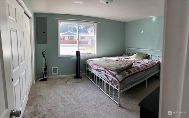 bedroom featuring light carpet and electric panel