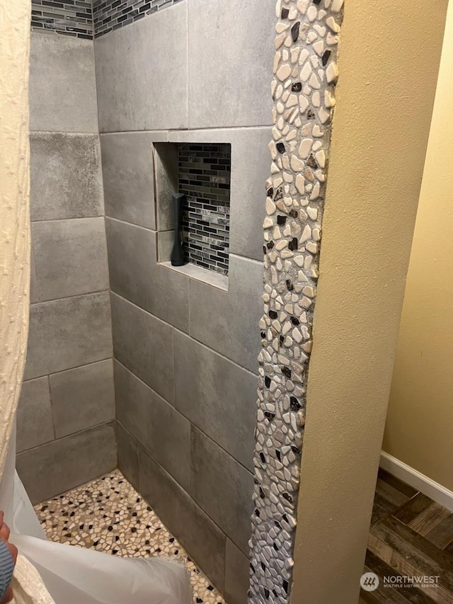 bathroom with hardwood / wood-style flooring and a shower with shower curtain