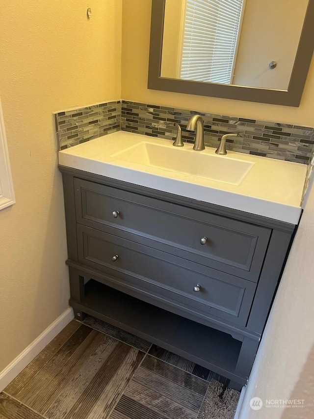 bathroom with vanity, backsplash, and hardwood / wood-style flooring