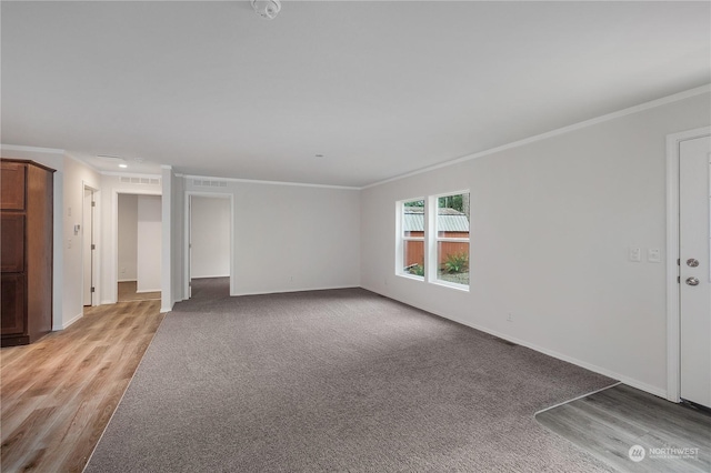 unfurnished living room featuring light carpet and crown molding