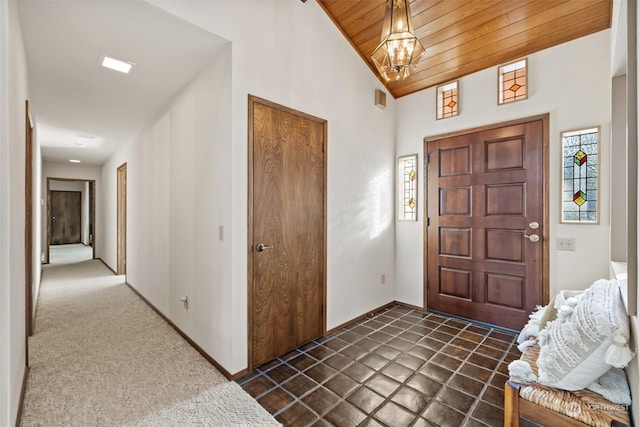 carpeted foyer with wooden ceiling, lofted ceiling, and a notable chandelier