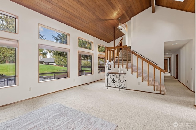 unfurnished living room featuring wooden ceiling, beam ceiling, carpet floors, and high vaulted ceiling