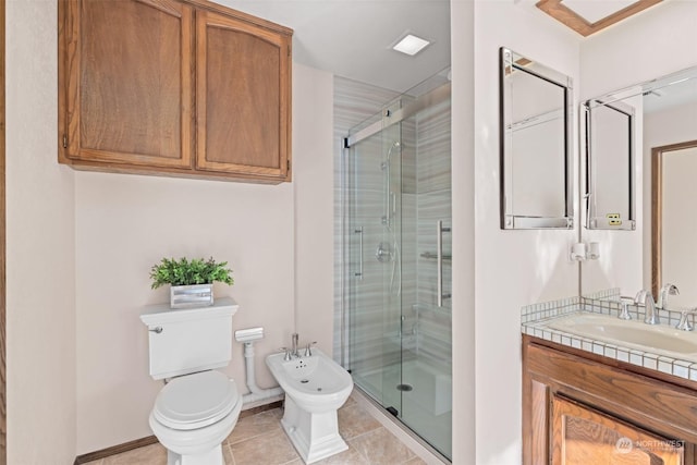 bathroom with tile patterned floors, walk in shower, a bidet, and vanity