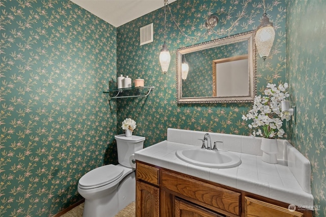 bathroom with toilet and vanity