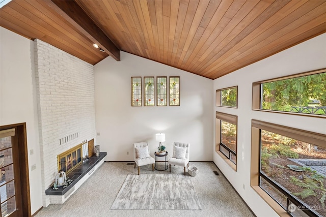 unfurnished room with a fireplace, lofted ceiling with beams, wood ceiling, and carpet floors