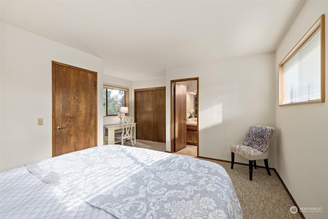 carpeted bedroom featuring ensuite bathroom