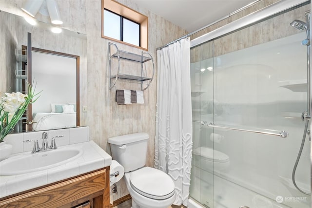 bathroom featuring toilet, a shower with shower curtain, and vanity