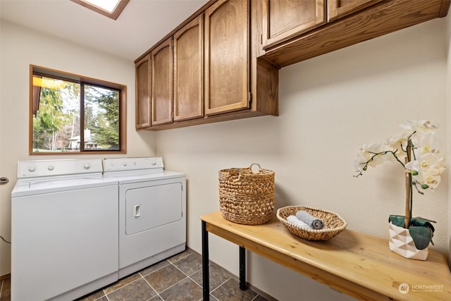 laundry area with washing machine and clothes dryer and cabinets