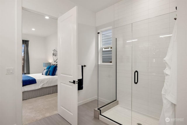 bathroom with walk in shower and wood-type flooring