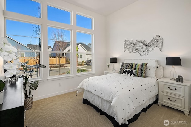 bedroom featuring multiple windows, carpet flooring, and baseboards