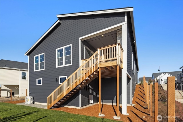 rear view of property with stairs and a wooden deck