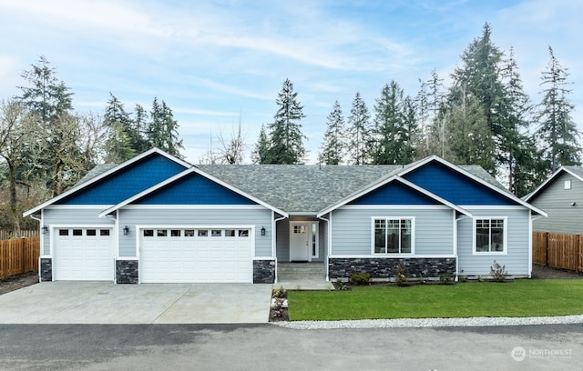 craftsman-style house featuring a garage and a front lawn