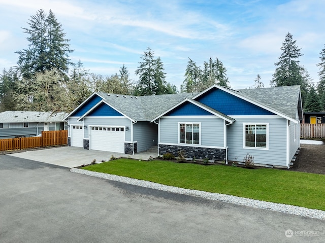 view of front facade featuring a garage and a front lawn