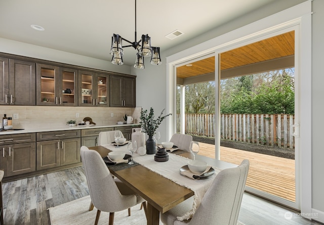 dining area with a chandelier and light wood-type flooring