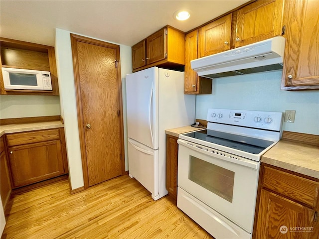 kitchen featuring light hardwood / wood-style floors and white appliances