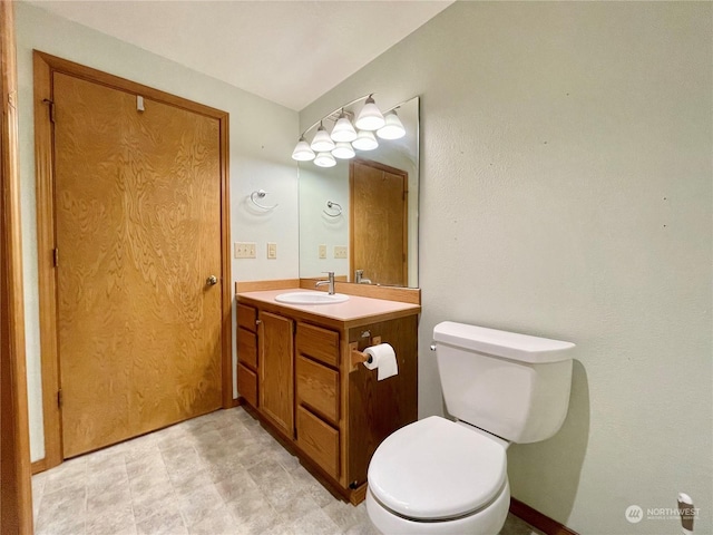 bathroom featuring toilet and vanity