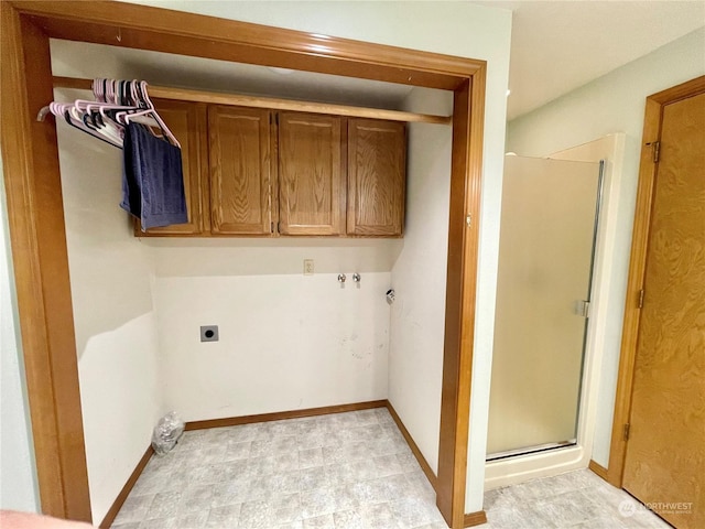 clothes washing area with cabinets and hookup for an electric dryer