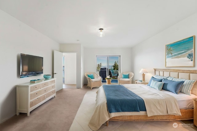 bedroom featuring access to exterior and light colored carpet