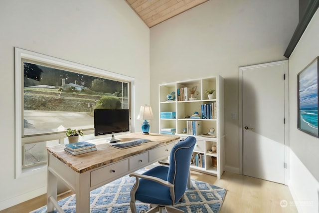 office space featuring vaulted ceiling and light hardwood / wood-style flooring