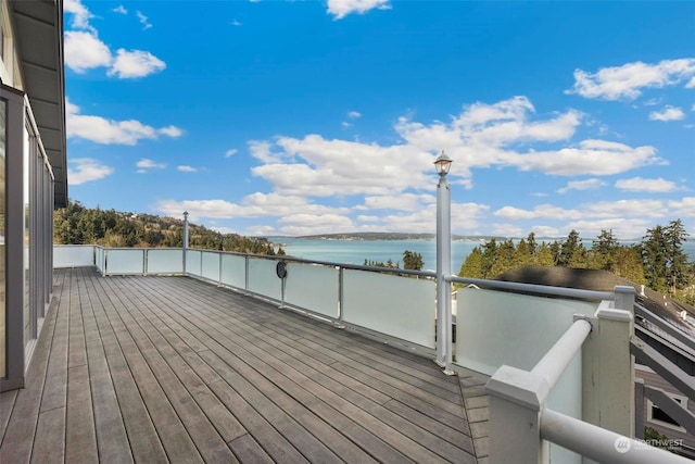 wooden deck featuring a water view