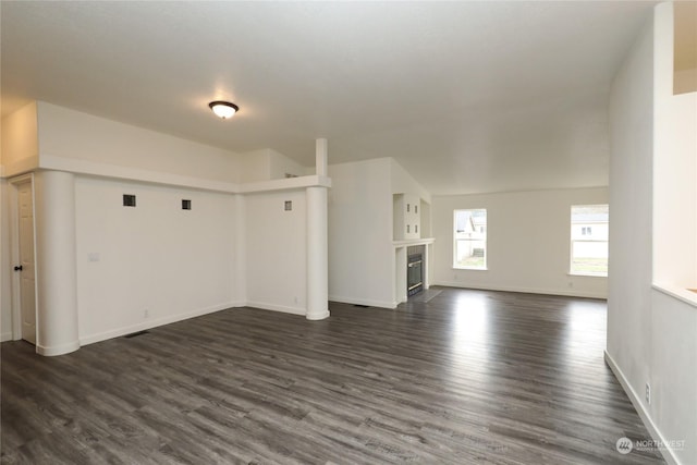 unfurnished living room with dark hardwood / wood-style flooring