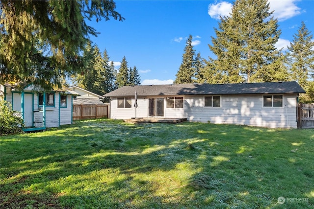 rear view of property with a lawn