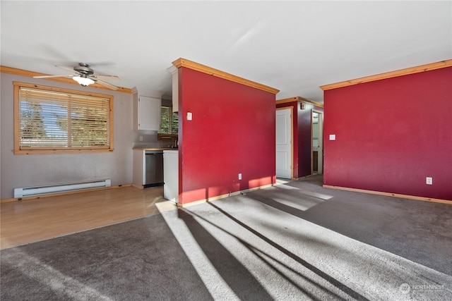 interior space featuring ornamental molding, a baseboard heating unit, and light colored carpet