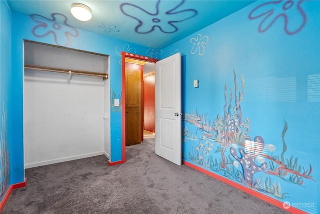 unfurnished bedroom featuring carpet floors and a closet