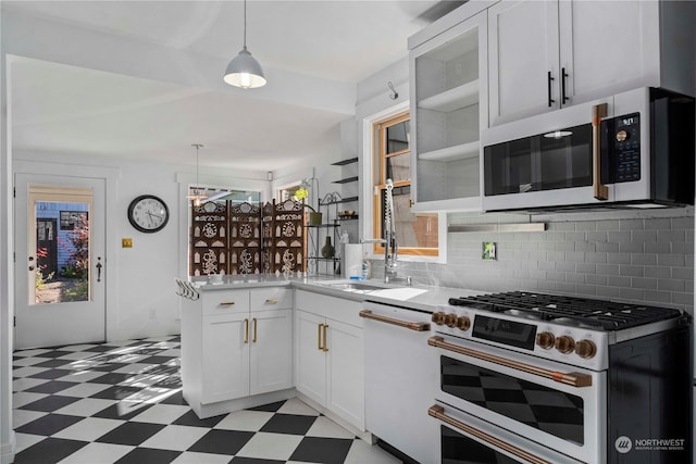 kitchen with white appliances, white cabinets, sink, backsplash, and hanging light fixtures